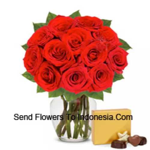 12 Red Roses With Some Ferns In A Glass Vase Accompanied With An Imported Box Of Chocolates