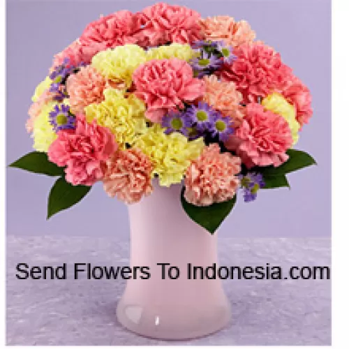 24 Mixed Colored Carnations With Seasonal Fillers In A Glass Vase