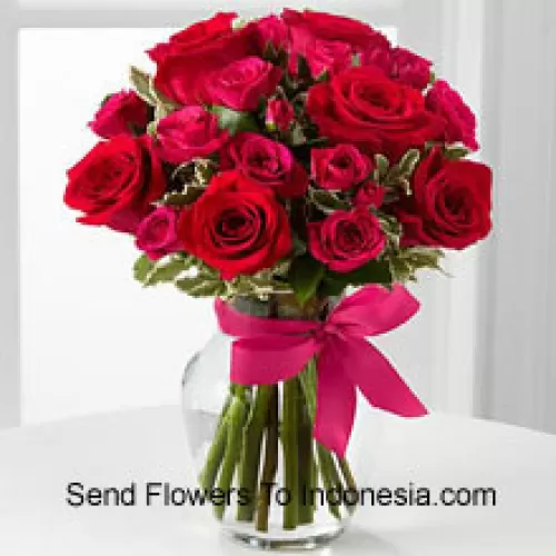 18 Red Roses With Seasonal Fillers In A Glass Vase Decorated With A Pink Bow