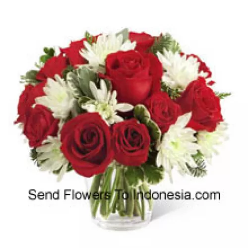 This Bouquet is a charming display of holiday beauty and winter warmth. Rich red roses and spray roses pop against white chrysanthemums, assorted Christmas greens and eucalyptus, arranged in a round clear glass vase to create a gift that will spread the goodwill of the season to your special recipient. (Please Note That We Reserve The Right To Substitute Any Product With A Suitable Product Of Equal Value In Case Of Non-Availability Of A Certain Product)