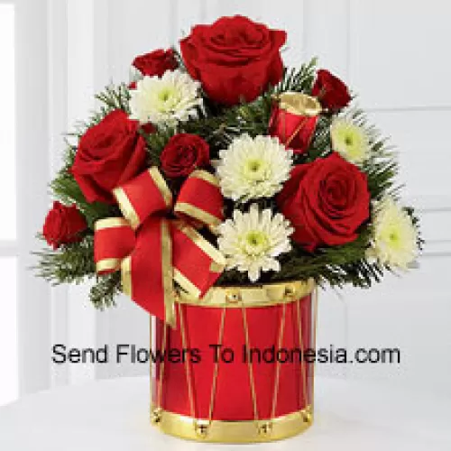 A blossoming display of seasonal merriment and festive greetings. Rich red roses and spray roses sweetly mingle with white chrysanthemums arranged amongst lush holiday greens, all perfectly accented with drum pics and a gold-edged red ribbon. Arriving in a designer red and gold drum inspired vase, this bouquet will express your most heartfelt wishes for a wonderful holiday season. (Please Note That We Reserve The Right To Substitute Any Product With A Suitable Product Of Equal Value In Case Of Non-Availability Of A Certain Product)